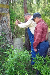 Back side of large marker telling where additional information may be obtained and when the graves were relocated.